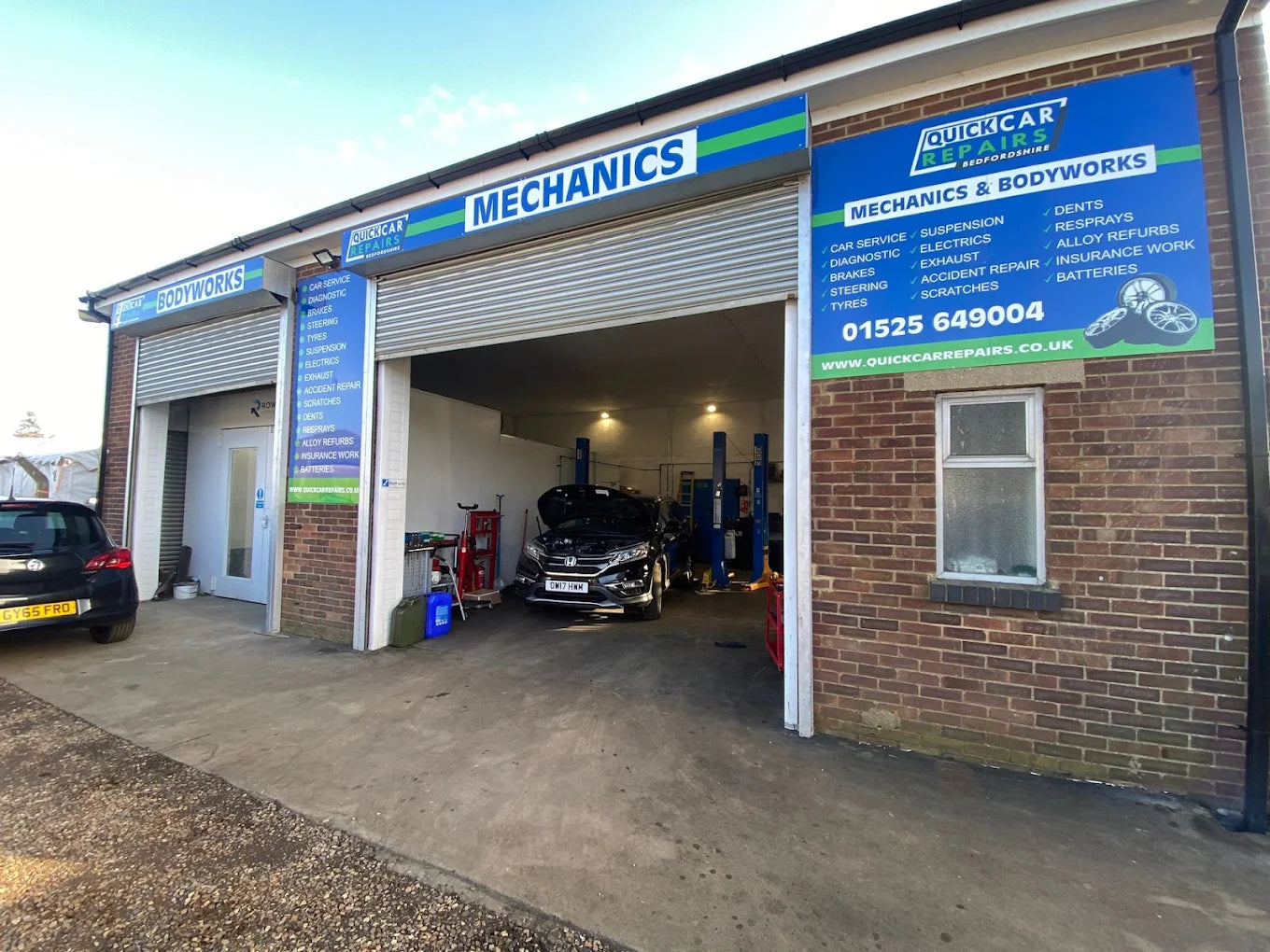 Exterior of Quick Car Repairs garage in Leighton Buzzard with service bays and signage