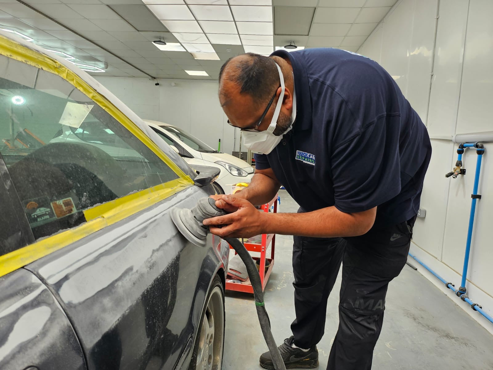 Fully equipped workshop at Quick Car Repairs in Leighton Buzzard with car ramps and repair tools